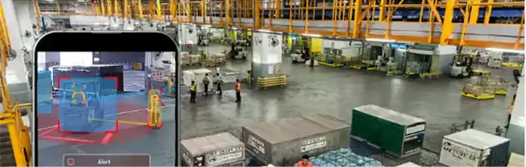 Cathay Cargo Terminal floor with cargo containers and workers, and a phone showing an Intenseye hazard alert in the foreground