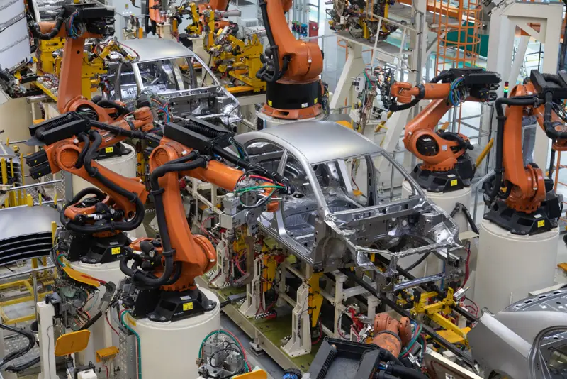 Robotic weld cells on an automotive body-shop line