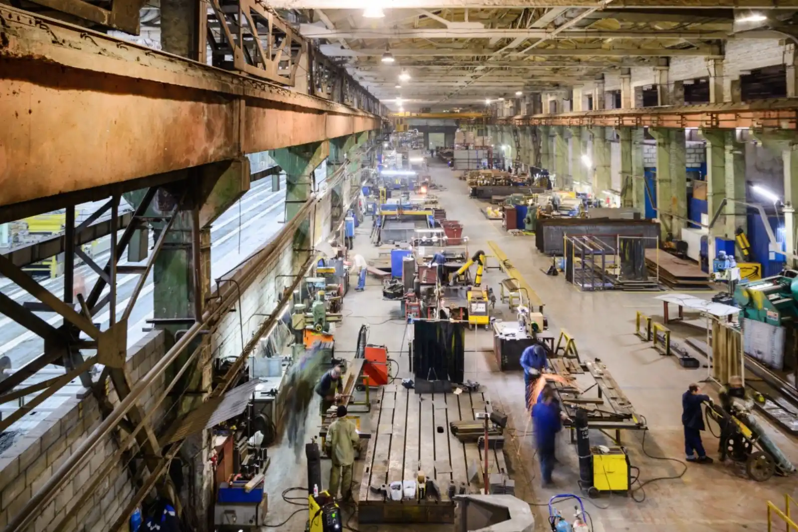 Industrial manufacturing floor with assembly lines and workers