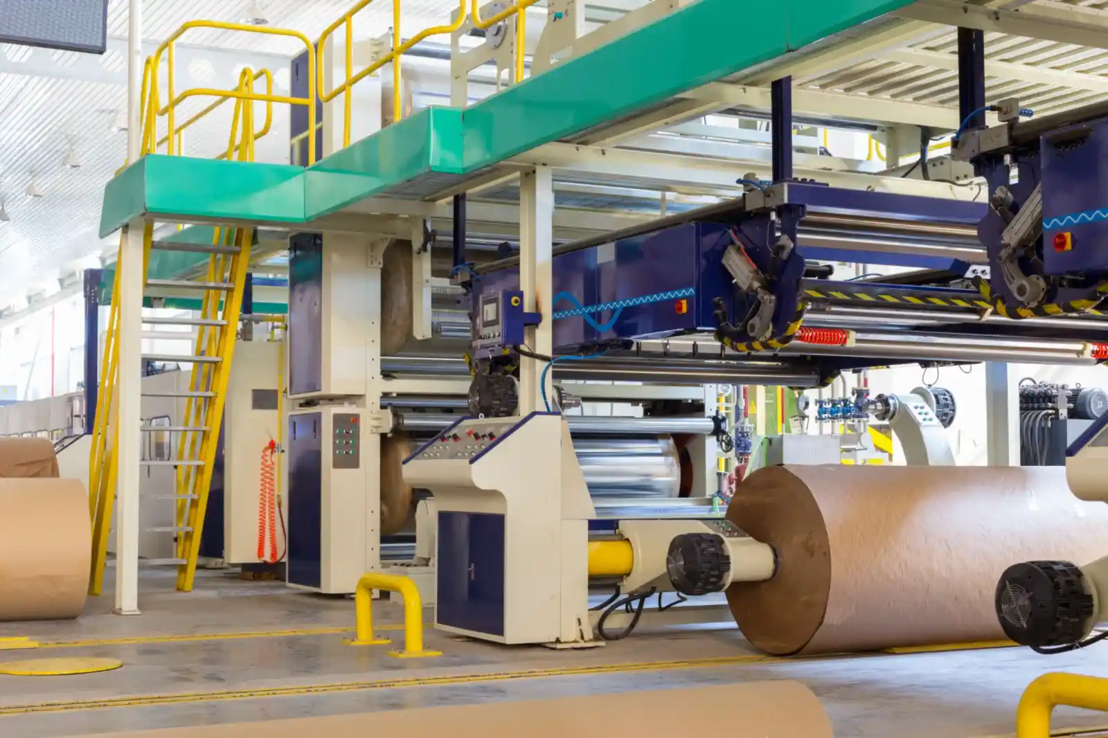 Paper mill floor with winders and stacked paper reels
