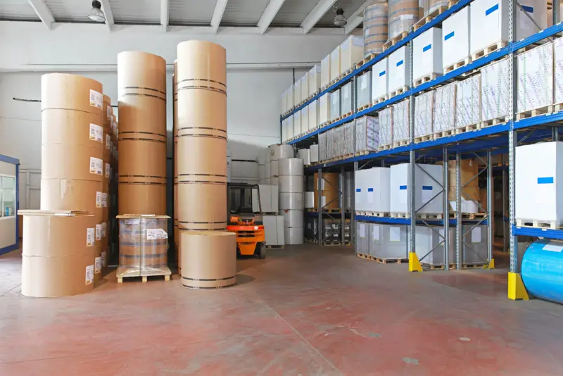 Paper reels stacked in a roll storage area