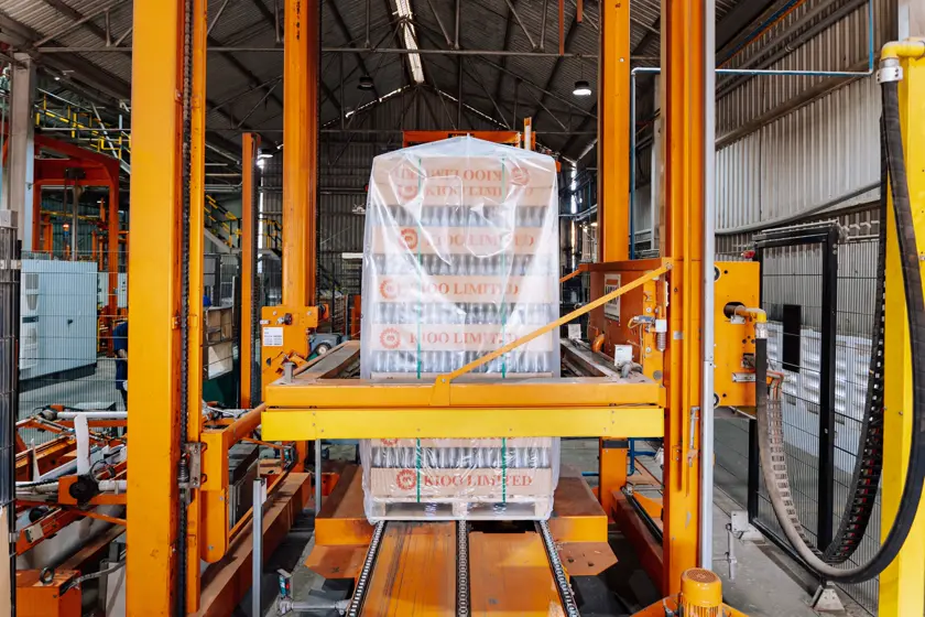Palletizer wrapping a stacked load on the packaging line