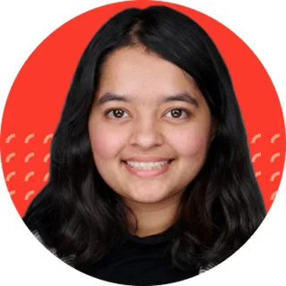Tanya Gupta smiling against a red Intenseye backdrop