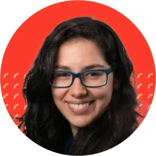 Yasemin Alev smiling, wearing glasses, against a red Intenseye backdrop