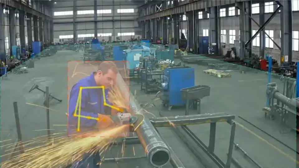 Worker without a hard hat grinding metal in a red detection box with a pose skeleton, sparks flying